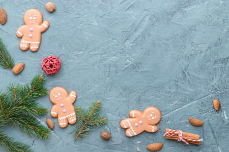 Christmas composition with gingerbread cookies on color background