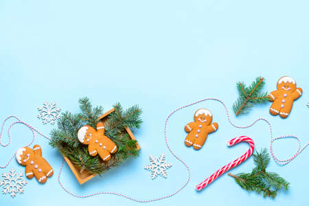 Christmas composition with gingerbread cookies on color background