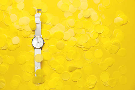 Wrist watch with confetti on color backgroundの写真素材