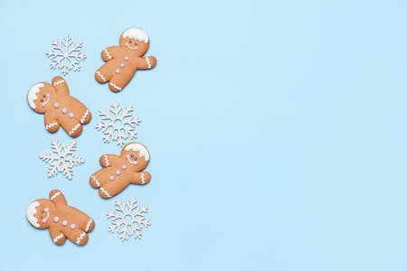 Christmas composition with gingerbread cookies on color background