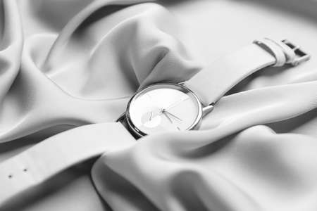 Wrist watch on fabric background