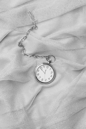 Pocket watch on fabric backgroundの写真素材
