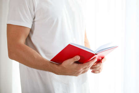 Man reading book at home, closeupの写真素材