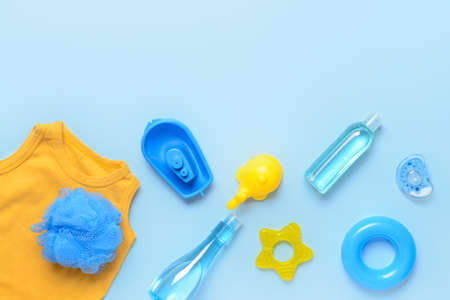 Bath accessories and clothing for baby on color backgroundの写真素材
