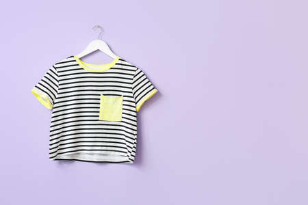 Stylish t-shirt hanging on color backgroundの写真素材