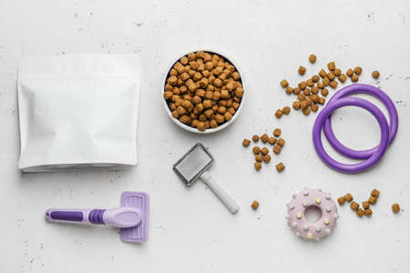 Tasty pet food and accessories on light backgroundの写真素材