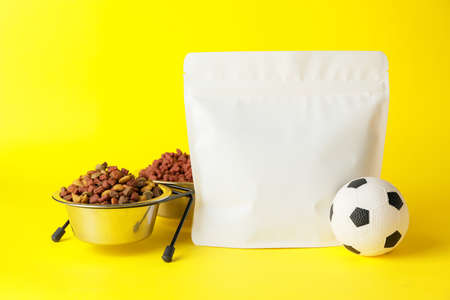 Tasty pet food and toy on color backgroundの写真素材