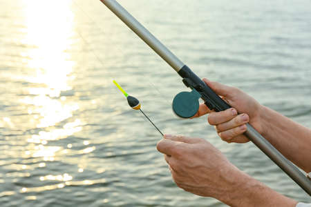 Man fishing on river bank