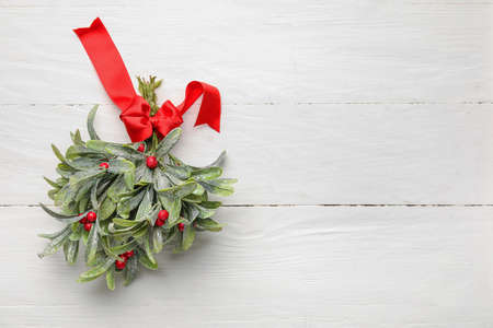 Mistletoe branch on white wooden backgroundの写真素材