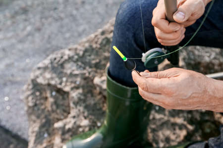 Man fishing on river bank, closeupの写真素材