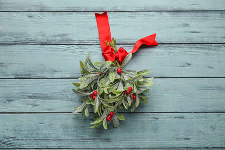 Mistletoe branch on wooden backgroundの写真素材