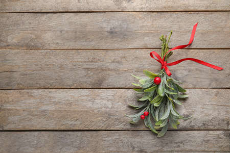 Mistletoe branch on wooden backgroundの写真素材