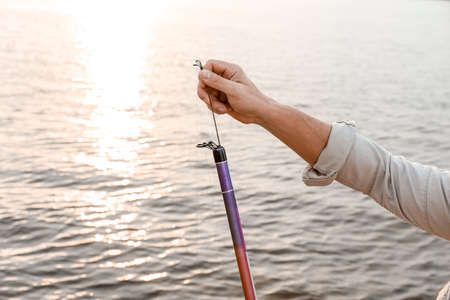 Man fishing on river bank
