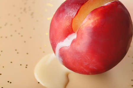 Cut peach and liquid on color background, closeup. Erotic conceptの写真素材