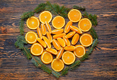 Heart made of oranges and fir branches on wooden backgroundの写真素材