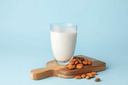 Glass of tasty almond milk on color backgroundの写真素材