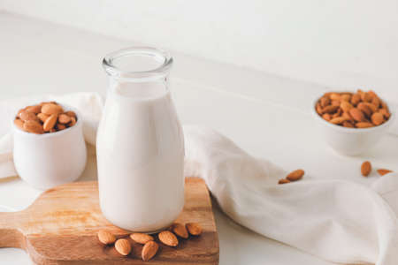 Bottle of tasty almond milk on light backgroundの写真素材