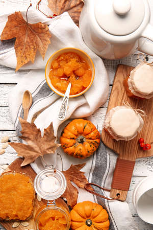 Autumn composition with tasty pumpkin jam on wooden backgroundの写真素材