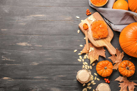 Autumn composition with tasty pumpkin jam on wooden backgroundの写真素材