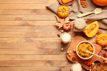 Autumn composition with tasty pumpkin jam on wooden backgroundの写真素材