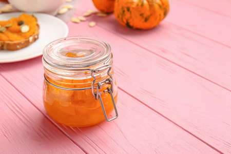 Jar of tasty pumpkin jam on tableの写真素材