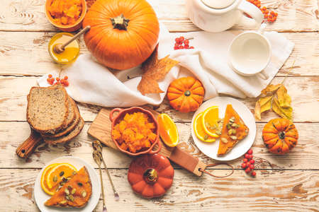 Autumn composition with tasty pumpkin jam on wooden backgroundの写真素材