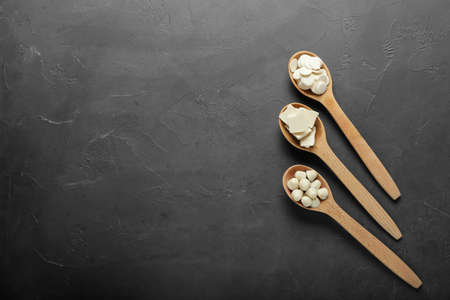 Spoons with chocolate drops on dark backgroundの写真素材