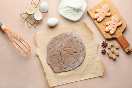 Fresh dough for gingerbread cookies on color background