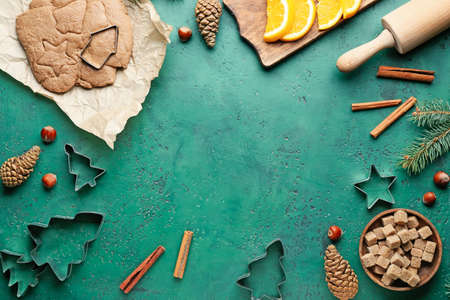 Composition with fresh dough for gingerbread cookies and cutters on color background