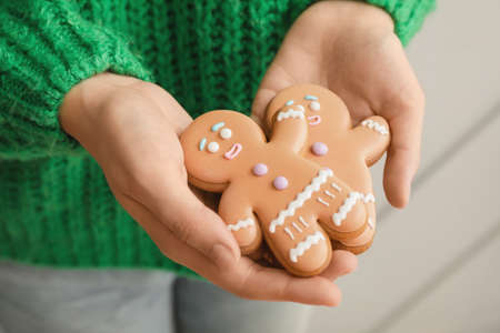 Woman holding Christmas cookies, closeup