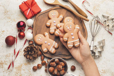 Woman holding tasty Christmas cookieの写真素材