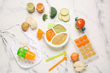 Composition with healthy baby food and ingredients on light backgroundの写真素材