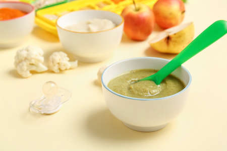 Bowls with healthy baby food on color background, closeupの写真素材