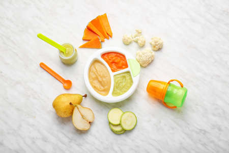 Composition with healthy baby food and ingredients on light backgroundの写真素材