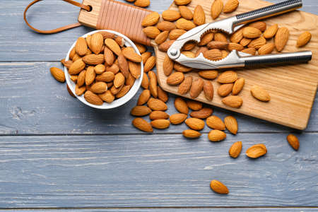 Composition with tasty almonds on wooden background
