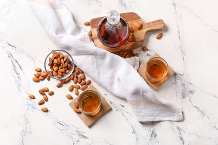 Composition with almond liquor and nuts on light backgroundの写真素材