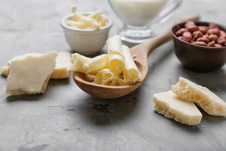 Spoon with white chocolate on grunge backgroundの写真素材