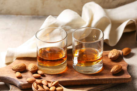 Glasses of almond liquor and nuts on tableの写真素材