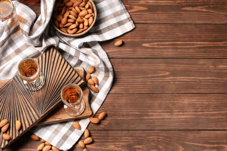 Composition with glasses of almond liquor and nuts on wooden backgroundの写真素材