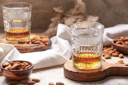 Glasses of almond liquor and nuts on tableの写真素材