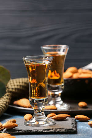 Composition with glasses of almond liquor and nuts on dark wooden backgroundの写真素材