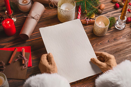 Santa Claus with empty letter at table