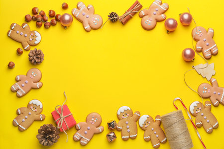 Frame made of tasty gingerbread cookies and Christmas decor on color backgroundの写真素材