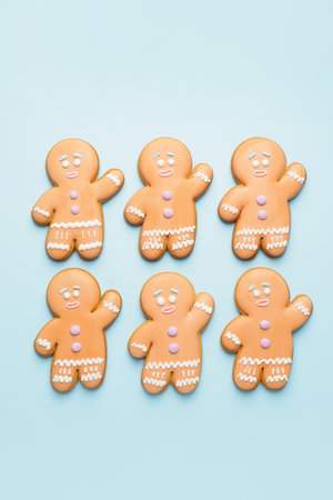 Tasty gingerbread cookies on color background