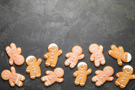 Tasty gingerbread cookies on dark background