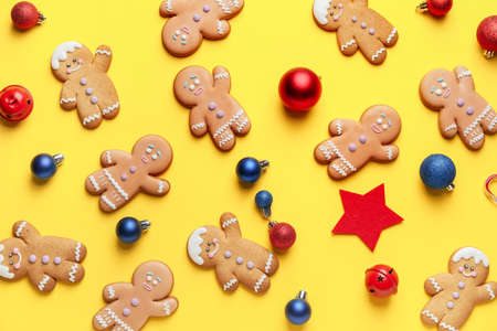 Tasty gingerbread cookies and Christmas decor on color backgroundの写真素材