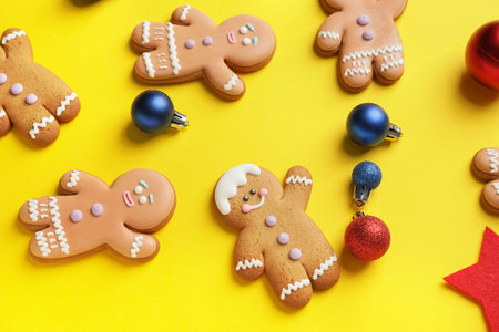 Tasty gingerbread cookies and Christmas decor on color backgroundの写真素材