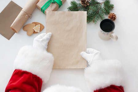Santa Claus with empty letter at table