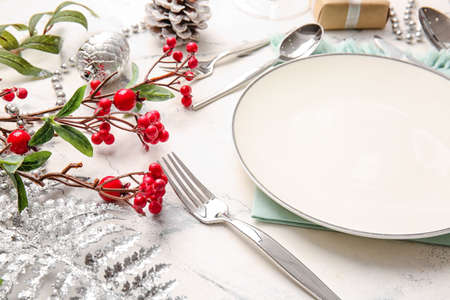 Beautiful Christmas table setting with mistletoe on white backgroundの写真素材