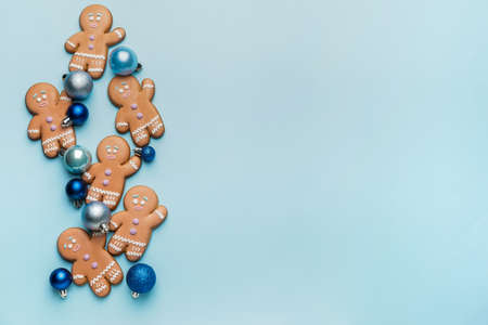 Tasty gingerbread cookies and Christmas decor on color backgroundの写真素材